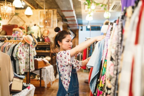 young woman shopping in a vintage clothing store - fashion stock pictures, royalty-free photos & images