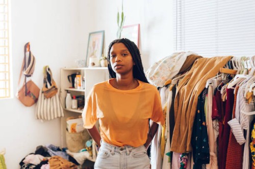 young woman standing in room - fashion stock pictures, royalty-free photos & images