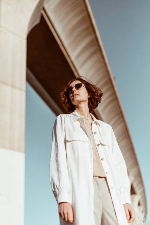 young woman standing under bridge at sunrise - fashion stock pictures, royalty-free photos & images