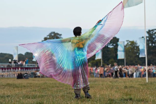 young woman standing with fanned out cape - concert stock-fotos und bilder
