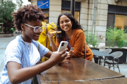 young woman using e-commerce services on a city break - junk food stock pictures, royalty-free photos & images