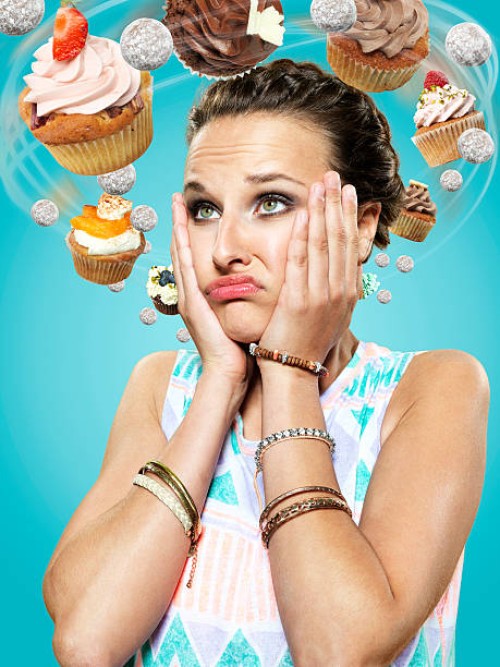 young woman with flying cupcakes around her head, composite - food stock pictures, royalty-free photos & images