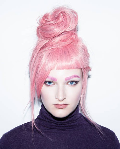 young woman with pink hair wig in an updo. - fashion stock pictures, royalty-free photos & images