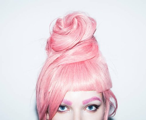 young woman with pink hair wig in an updo, crop. - hairstyle stock-fotos und bilder