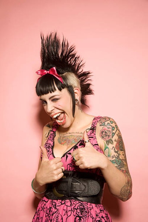 young woman with tattoos giving the thumbs-up - hairstyle stock pictures, royalty-free photos & images
