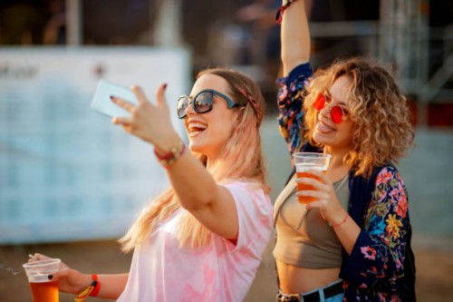 young women with beer cups taking selfie and making faces - concert stock pictures, royalty-free photos & images