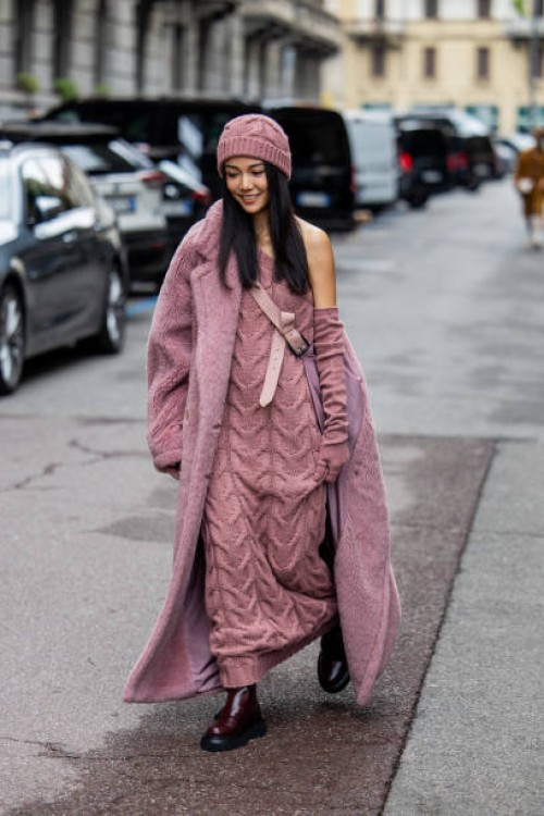 Yoyo Cao wears lavender knit dress, teddy coat, beanie outside Max Mara during the Milan Fashion Week - Womenswear Spring/Summer 2024 on September...
